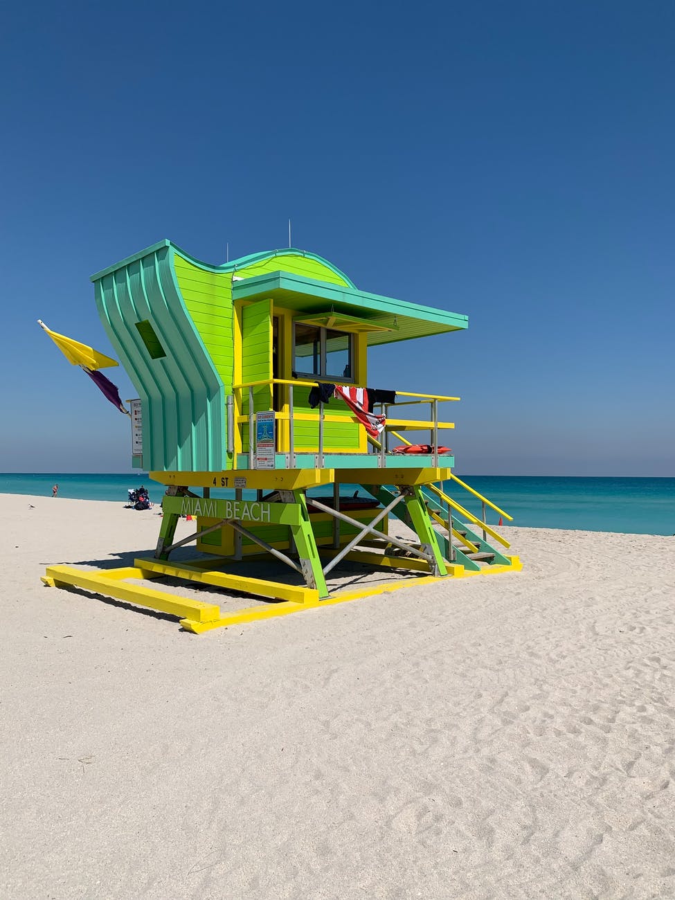 green wooden lifeguard house on beach